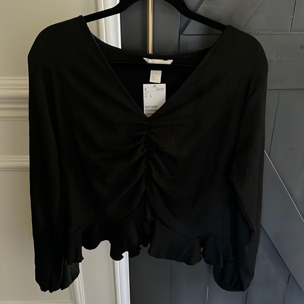 H&M black top with ruching and bottom ruffle